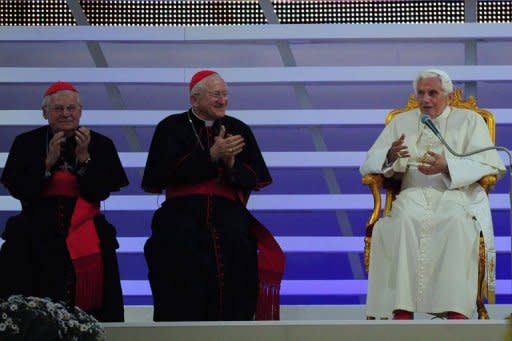 Pope Benedict XVI (R) delivers a speech during a meeting with families for the feast of testimonies at the park of Bresso as part of the 7th World Meeting of Families in Milan. Tens of thousands of young Catholics greeted Pope Benedict XVI in Italy's northern city of Milan on Saturday in a welcome distraction from Vatican infighting for the aged pontiff