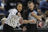 FILE - South Carolina head coach Dawn Staley speaks with an official during the first half of a college basketball game against Creighton in the Elite 8 round of the NCAA tournament in Greensboro, N.C., Sunday, March 27, 2022. Staley said referees on the men's side should be “stepping up” and advocating for equal pay for women's referees. “They don't do anything different," she said. “Why should our officials get paid less for taking the (expletive) we give them?" (AP Photo/Gerry Broome, File)