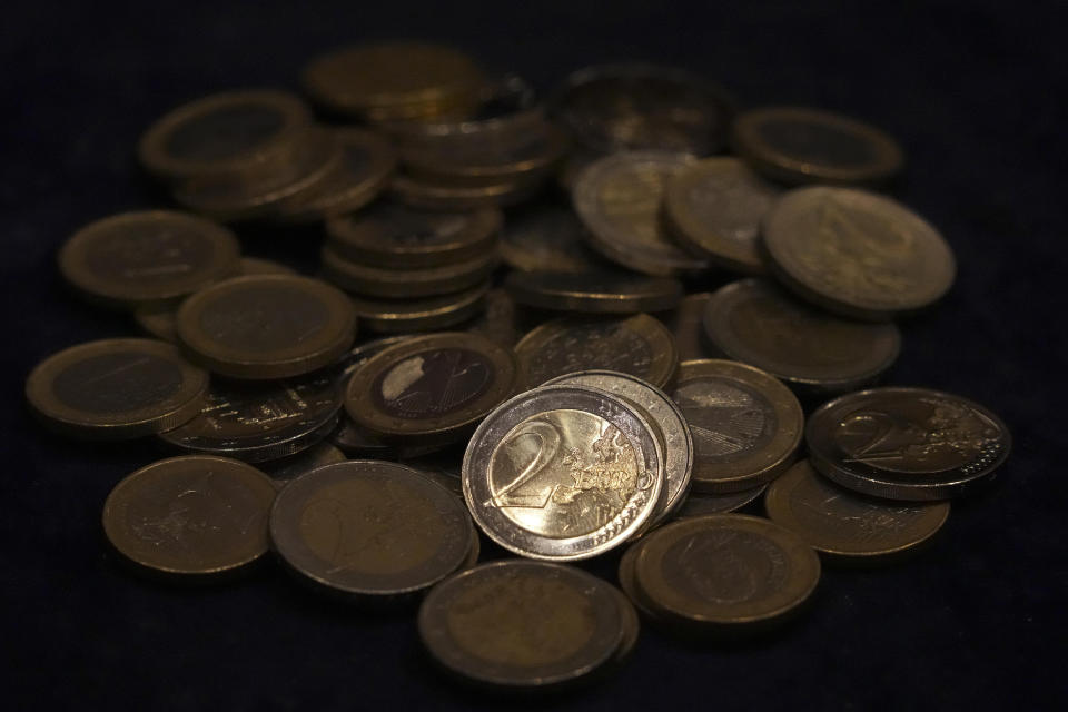 FILE - Euro coins lie on a table in Munich, Germany on March 30, 2022. Finance ministers from the 19 countries that share the euro currency may decide Thursday, June 16, 2022 on a successor to Germany’s Klaus Regling as managing director of the European Stability Mechanism. (AP Photo/Matthias Schrader, File)