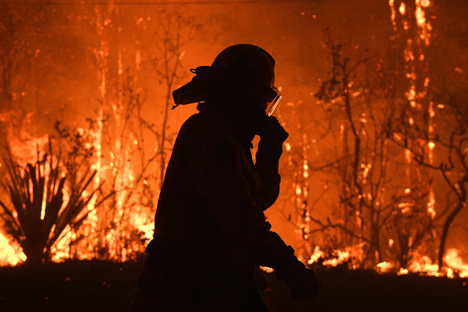 NSW Rural Fire Service crews protect properties on Waratah Road and Kelyknack Road as the Wrights Creek fire approaches Mangrove Mountain north of Sydney.