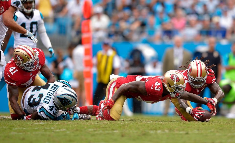 <p>Chris Davis #43 and Ray-Ray Armstrong #54 of the San Francisco 49ers dive on a ball that was fumbled by Fozzy Whittaker #43 of the Carolina Panthers during the game at Bank of America Stadium on September 18, 2016 in Charlotte, North Carolina. (Photo by Grant Halverson/Getty Images) </p>