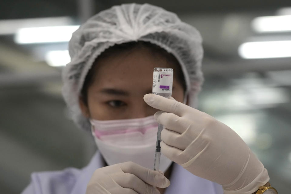 A health worker prepares a shot of the AstraZeneca COVID-19 vaccine for people at the Central Vaccination Center in Bangkok, Thailand, Thursday, July 22, 2021. (AP Photo/Sakchai Lalit)