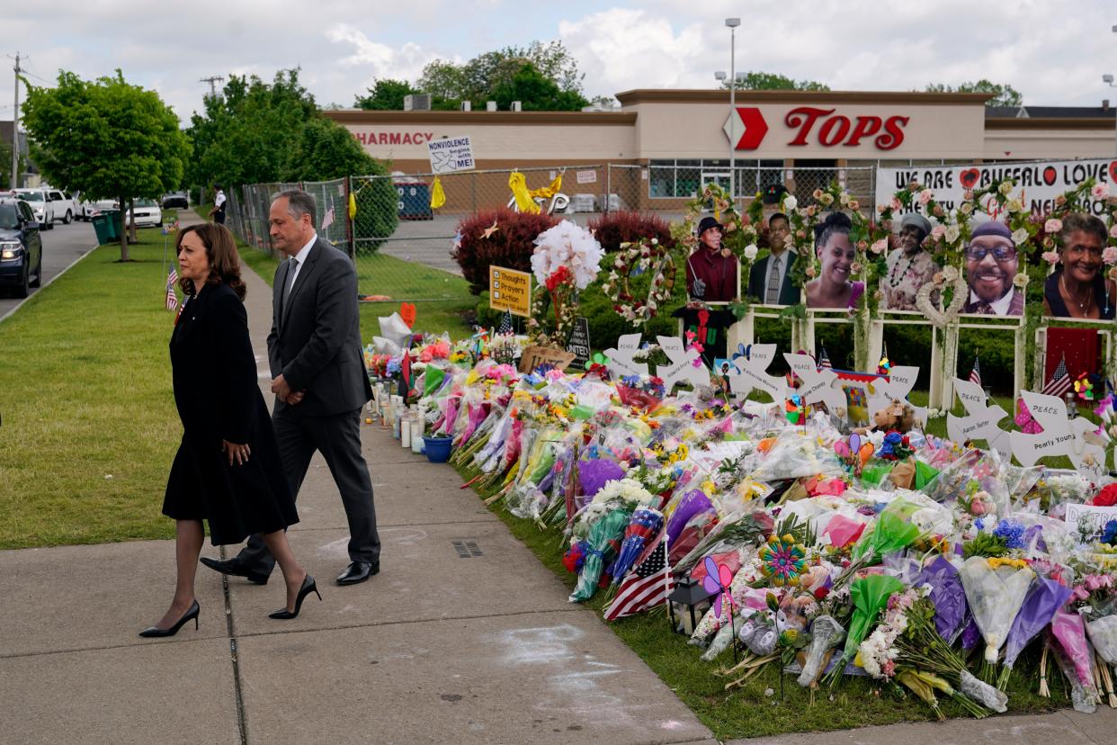 Vice President Kamala Harris and her husband Doug Emhoff visit a memorial near the site of the Buffalo supermarket shooting on May 28, 2022, in Buffalo, N.Y. A new DHS memo warns that other attackers may use similar racist conspiracy theories allegedly used by the Buffalo shooter to rationalize attacks against people of color.