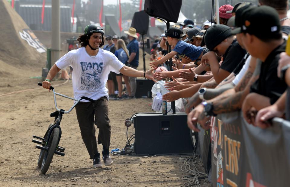 Kevin Peraza high-fives his fans at the BMX Dirt Elimination at the X Games competition at the Ventura County Fairgrounds on Friday, July 21, 2023.