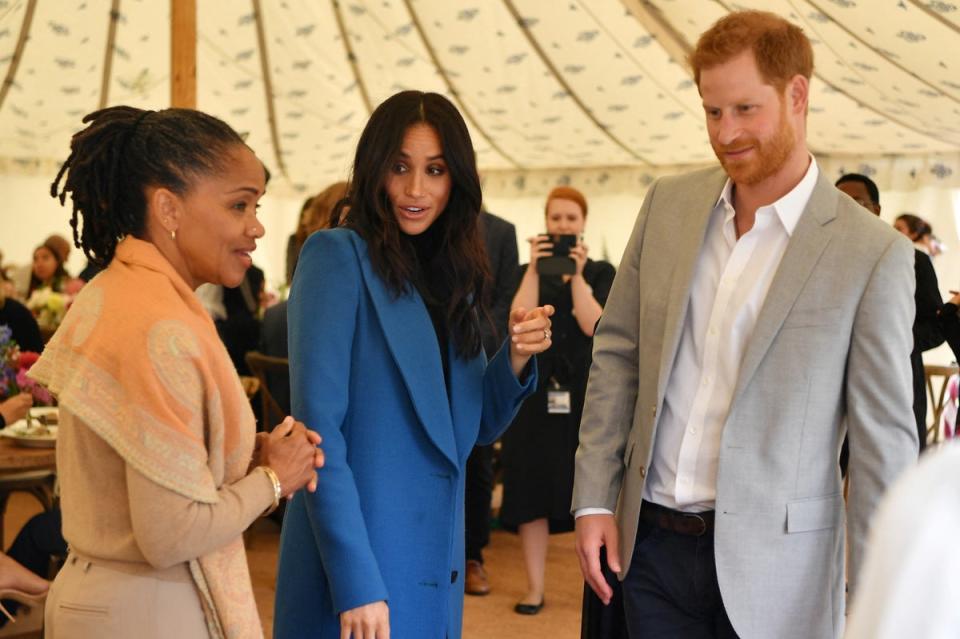 ILE PHOTO: Meghan, Duchess of Sussex, her mother, Doria Ragland and Britain's Prince Harry take part in the launch of a cookbook with recipes from a group of women affected by the Grenfell Tower fire at Kensington Palace in London (REUTERS)