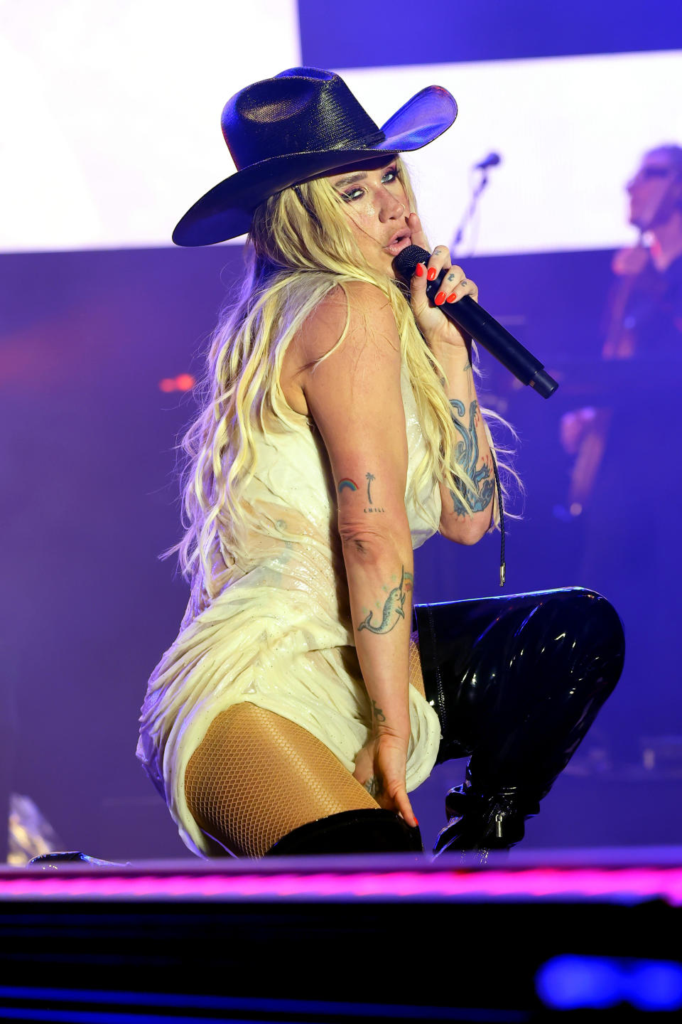 Kesha performs onstage during OUTLOUD Music Festival at 2024 WeHo Pride on May 31, in a short white dress, black cowboy hat, and thigh-high boots in West Hollywood, California. (Photo by Amy Sussman/Getty Images)