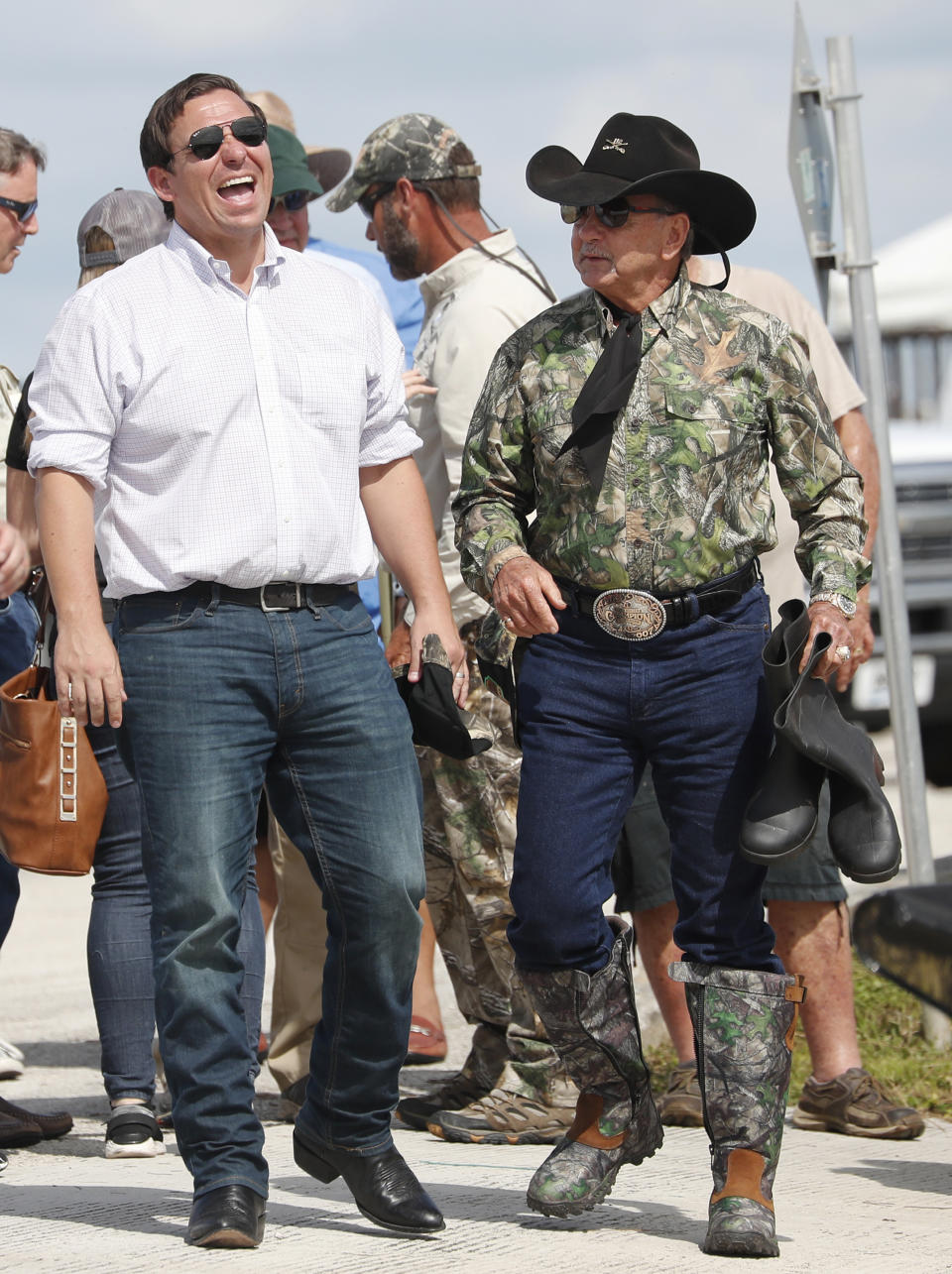 Republican candidate for Florida Governor Ron DeSantis, shares a laugh with Gladesman and former Florida Fish and Wildlife Conservation commissioner Ron Bergeron before an airboat tour of the Florida Everglades, Wednesday, Sept. 12, 2018, in Fort Lauderdale, Fla. (AP Photo/Wilfredo Lee)
