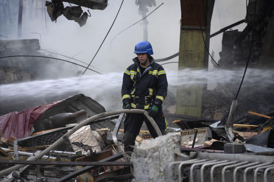 Firefighters put out a fire after a Russian rocket attack in Kyiv, Ukraine, Wednesday, Aug. 30, 2023. Over 20 rockets and drones have been shot down by the air defence system in Kyiv overnight. (AP Photo/Efrem Lukatsky)