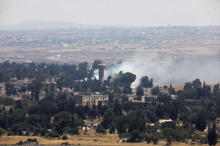 Smoke following an explosion is seen at Quneitra at the Syrian side of the Israeli Syrian border as it is seen from the Israeli-occupied Golan Heights, Israel July 22, 2018. REUTERS/Ronen Zvulun