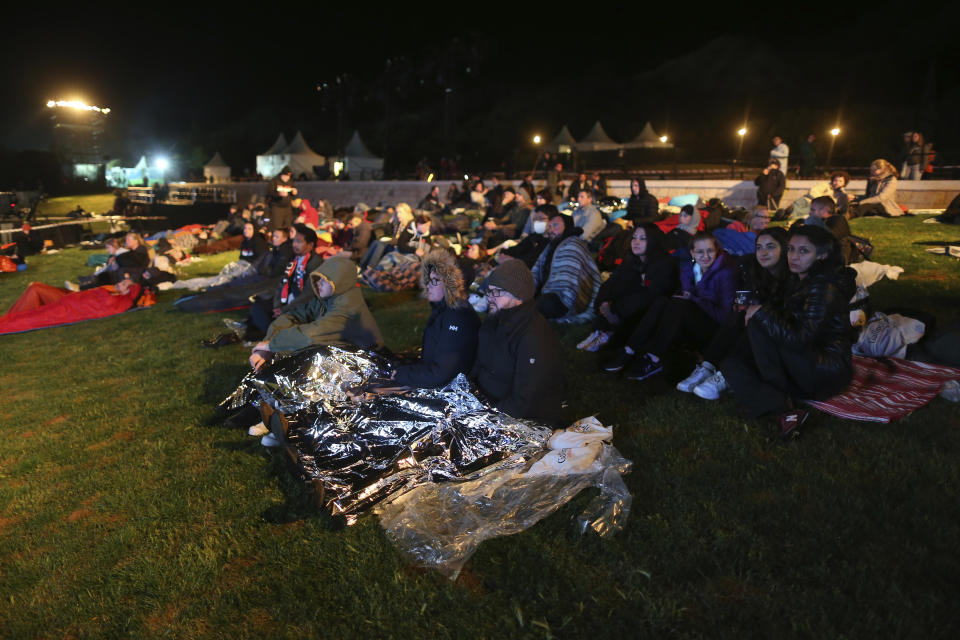 People spend the night before attending the Dawn Service ceremony at the Anzac Cove beach, the site of the April 25, 1915, World War I landing of the ANZACs (Australian and New Zealand Army Corps) on the Gallipoli peninsula, Turkey, early Monday, April 25, 2022. Travelers from Australia and New Zealand joined Turkish and other nations' dignitaries at the former World War I battlefields for a dawn service on Monday to remember troops killed during an unsuccessful British-led campaign that aimed to take the Ottoman Empire out of the war. (AP Photo/Emrah Gurel)