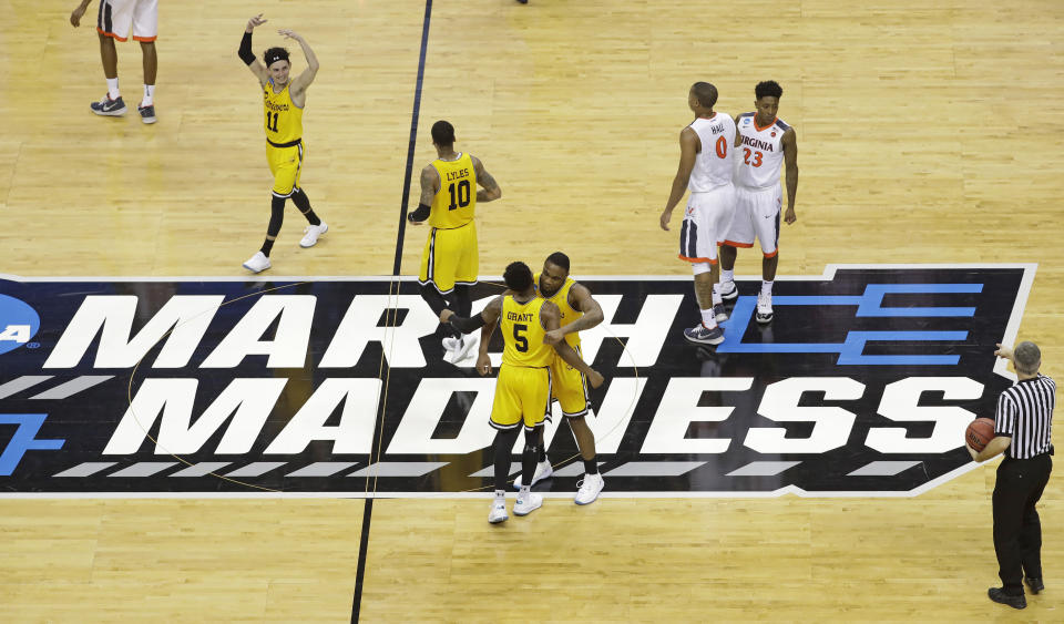 FILE - UMBC players celebrate their 74-54 win over Virginia in a first-round game in the NCAA men's college basketball tournament in Charlotte, N.C., March 16, 2018. Five years ago Thursday a tiny school few had ever heard of — and virtually no one gave an ounce of a chance to win — pulled off the biggest upset in NCAA Tournament history as University of Maryland-Baltimore County knocked off the tournament’s top overall seed, elevating March Madness to a whole new level. (AP Photo/Chuck Burton, File)
