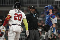 Home plate umpire Alan Porter, center, gets between Atlanta Braves designated hitter Marcell Ozuna (20) and Los Angeles Dodgers catcher Will Smith, right, as they exchange words in the sixth inning of a baseball game, Monday, May 22, 2023, in Atlanta. (AP Photo/John Bazemore)