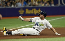 Tampa Bay Rays' Austin Meadows slides into third base with a triple off Miami Marlins' Sandy Alcantara during the fourth inning of a baseball game Saturday, Sept. 25, 2021, in St. Petersburg, Fla. (AP Photo/Steve Nesius)