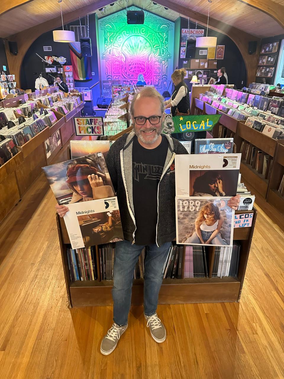 Doyle Davis, co-owner of "Grimey's" in East Nashville holds some of Swift's more popular vinyl records.