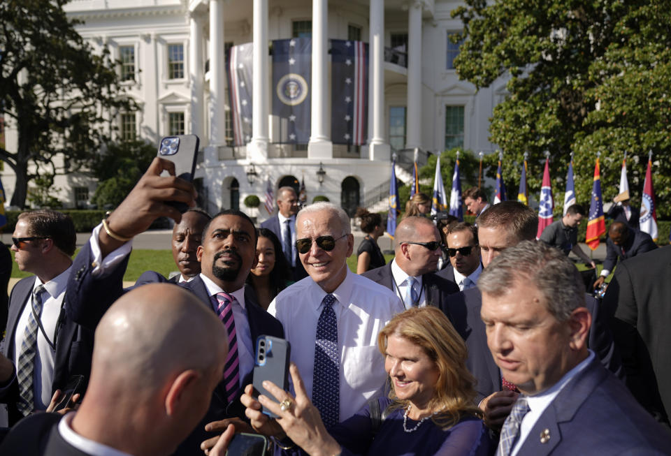 President Joe Biden poses for a photo after speaking about the Inflation Reduction Act of 2022 during a ceremony on the South Lawn of the White House in Washington, Tuesday, Sept. 13, 2022. (AP Photo/Andrew Harnik)