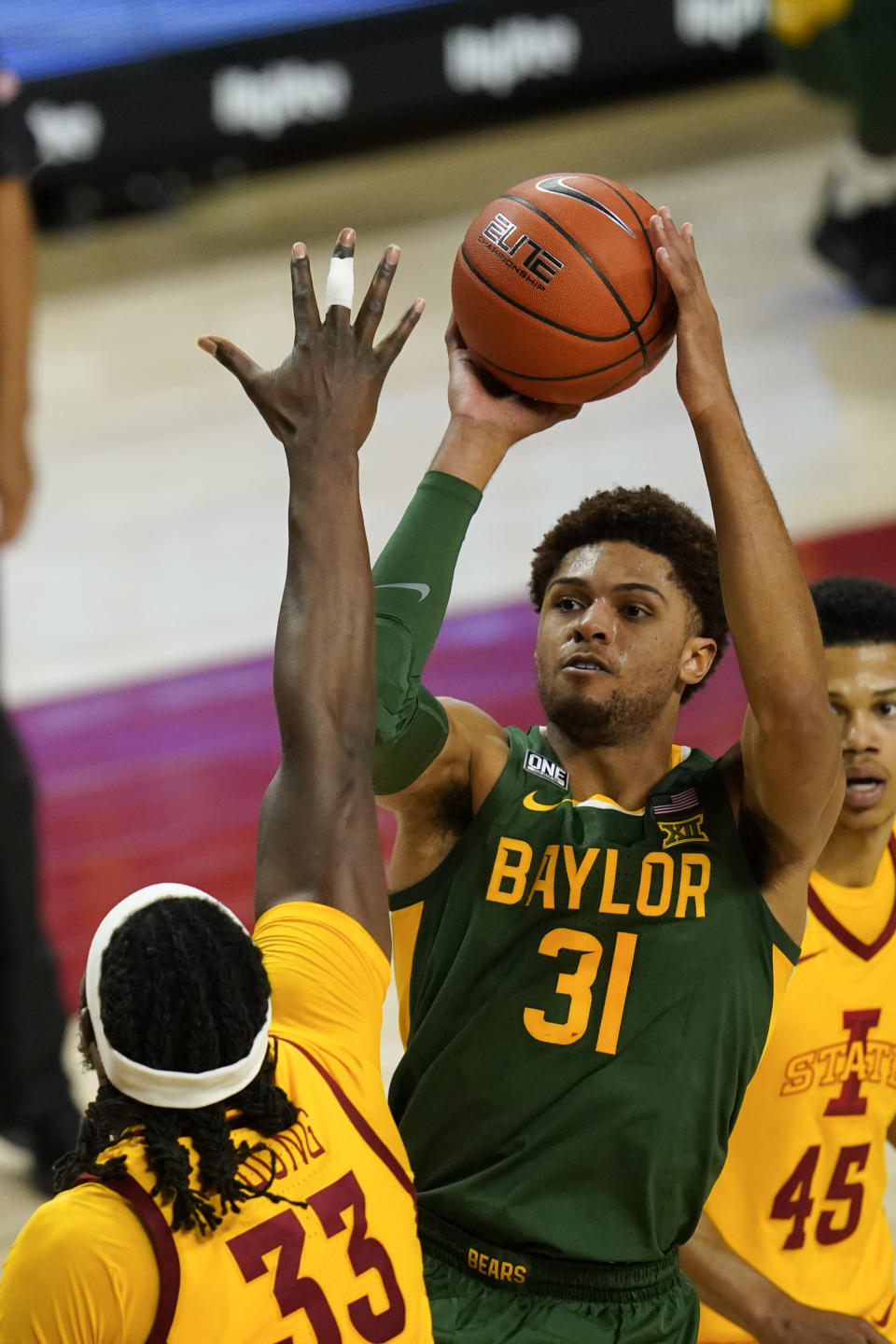 Baylor guard MaCio Teague (31) shoots over Iowa State forward Solomon Young (33) during the second half of an NCAA college basketball game, Saturday, Jan. 2, 2021, in Ames, Iowa. Baylor won 76-65. (AP Photo/Charlie Neibergall)