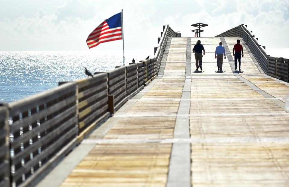 Officials walk on the Jacksonville Beach Pier shortly before the official grand reopening ceremony Wednesday morning.