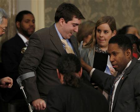 Boston Marathon bombing survivor Jeff Bauman, who had to have both his legs amputated after being injured in the blasts, arrives before the start of U.S. President Barack Obama's State of the Union speech on Capitol Hill in Washington January 28, 2014.