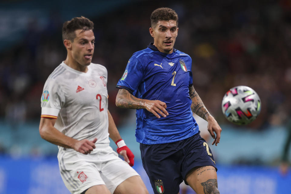 Spain's Cesar Azpilicueta, left, duels for the ball with Italy's Giovanni Di Lorenzo during the Euro 2020 soccer championship semifinal match between Italy and Spain at Wembley stadium in London, England, Tuesday, July 6, 2021. (Carl Recine/Pool Photo via AP)