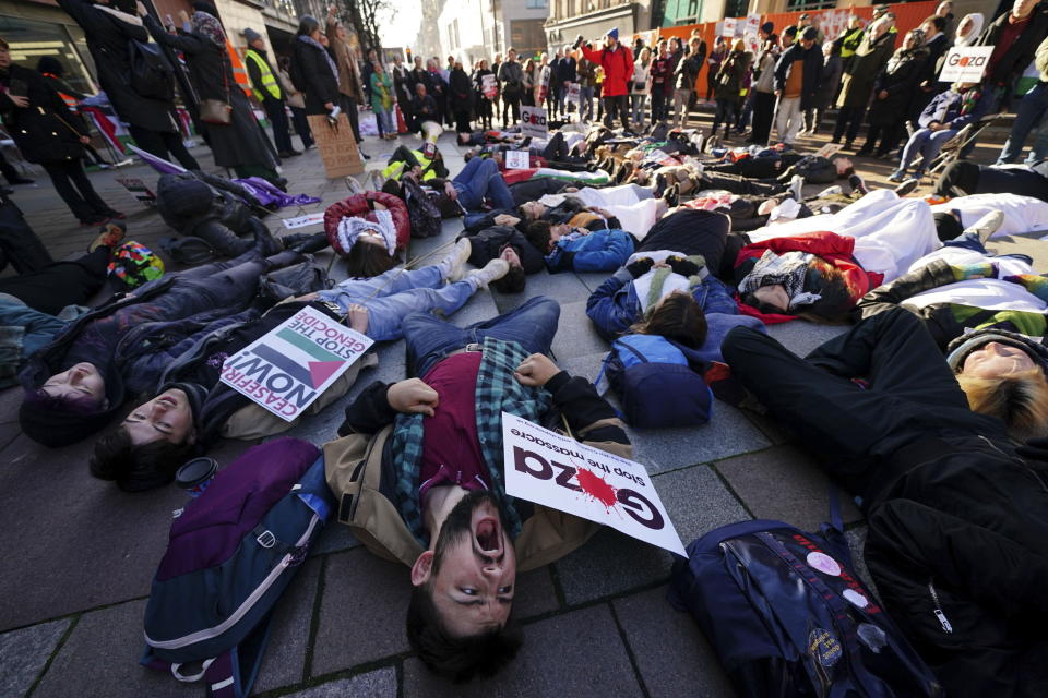 People take part in a die-in ahead of a Scottish Palestinian Solidarity Campaign demonstration in Glasgow, Scotland, Saturday, Nov. 11, 2023. (Jane Barlow/PA via AP)