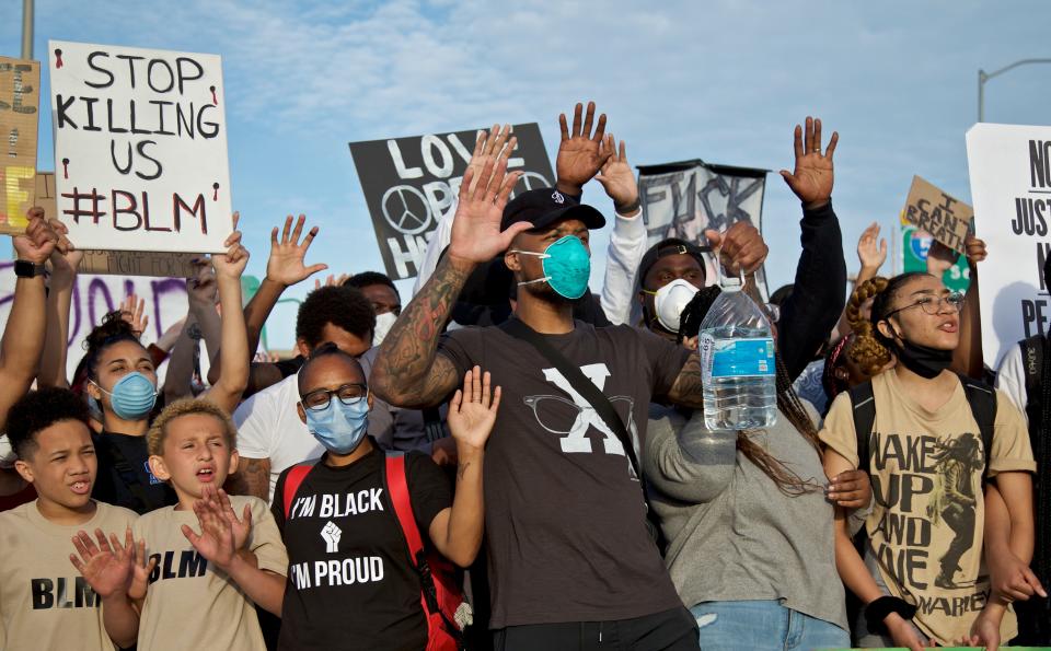 Damian Lillard, center, of the Portland Trail Blazers, joins demonstrators in Portland, Ore., during a protest against police brutality and racism.