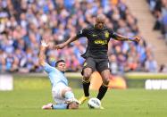 Manchester City's Sergio Aguero and Wigan Athletic's Emmerson Boyce (right) battle for the ball