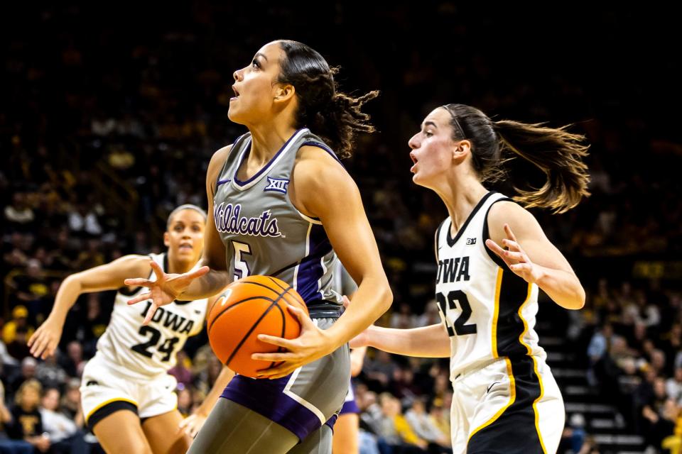 Kansas State guard Brylee Glenn (5) drives to the basket as Iowa guard Caitlin Clark (22) defends during NCAA women's basketball game, Thursday, Nov. 16, 2023, at Carver-Hawkeye Arena in Iowa City, Iowa.