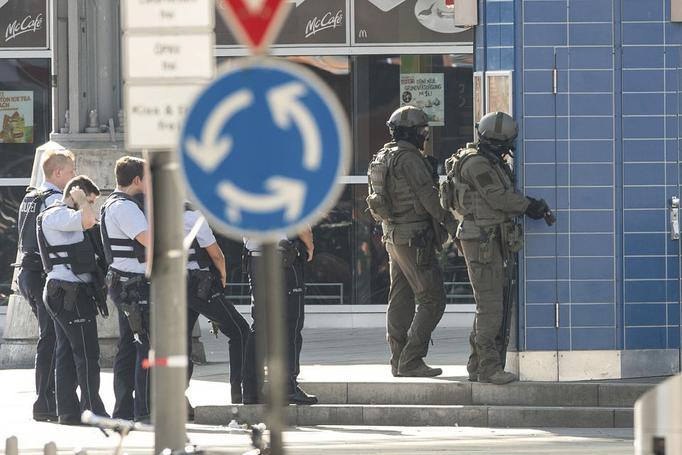 Special police operate outside the Cologne, western Germany, train station Monday, Oct. 15, 2018. Cologne police closed parts of the western German city’s main train station after a man took a woman hostage in a pharmacy inside. (Oliver Berg/dpa via AP)