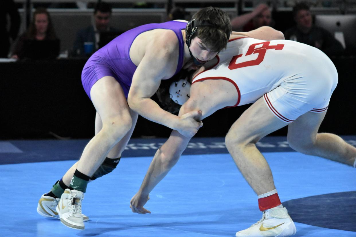 Delaney Ruhlman grapples with Crown Point's Samuel Goins during their state championship match at Gainbridge Fieldhouse.