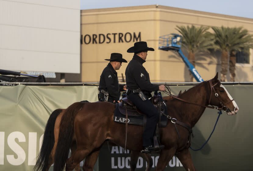 CANOGA PARK, CA - December 06 2021: LAPD mounted unit officers Daniel, right, and Morales, left, patrol the Westfield Topanga shopping mall on Monday, Dec. 6, 2021 in Canoga Park, CA. (Brian van der Brug / Los Angeles Times