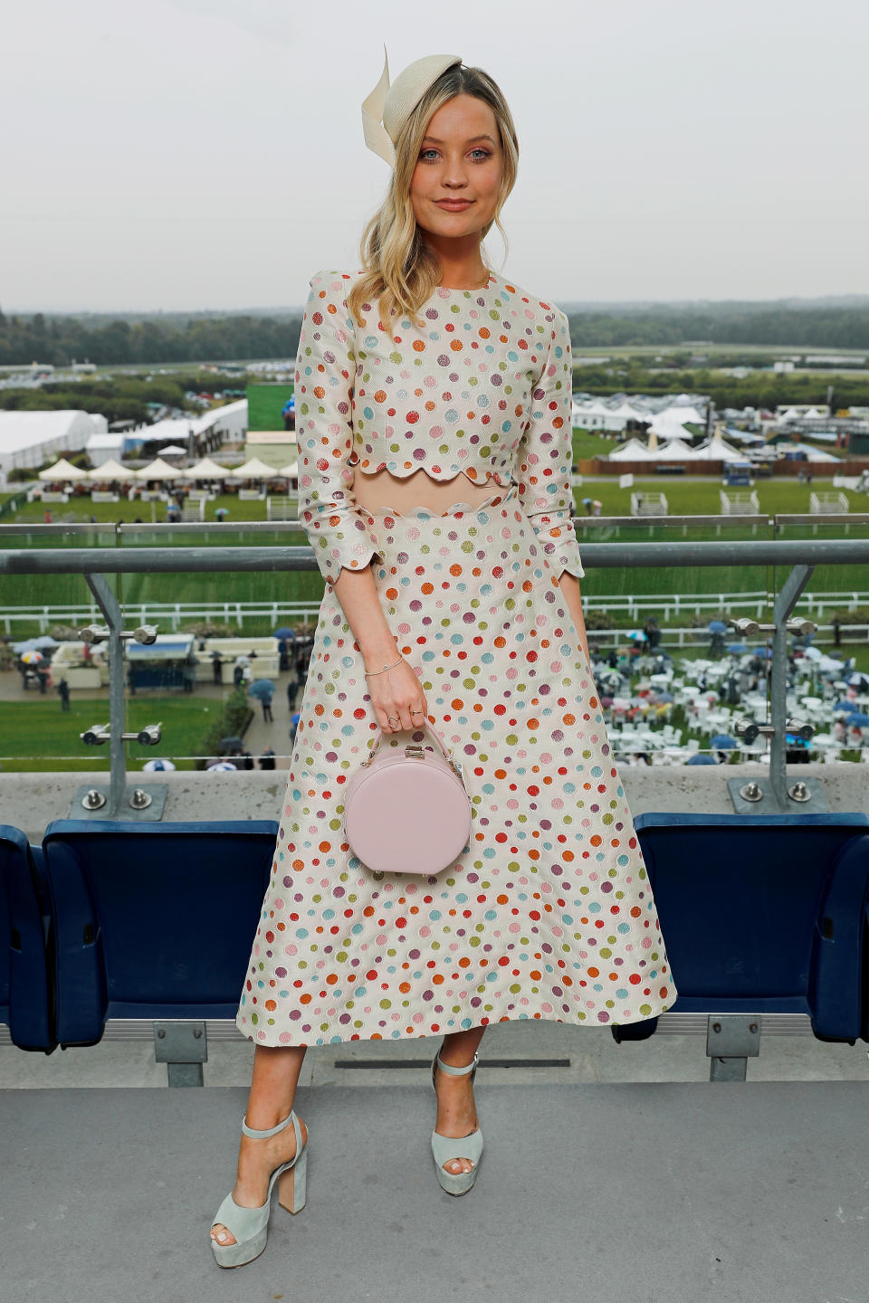 TV presenter Laura Whitmore wears a polka dot dress by London Fashion Week label Tata Naka with an Aspinal of London bag, Gina shoes and a Philip Treacy hat. <em>[Photo: Getty]</em>