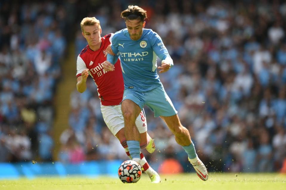 Odegaard (left) made his Arsenal return against Manchester City (AFP via Getty Images)