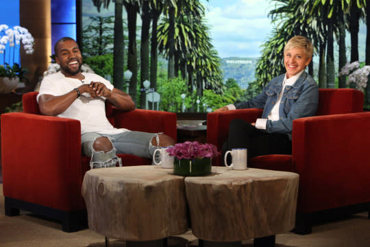 Kanye West sitting down with Ellen DeGeneres on the set of her show. 