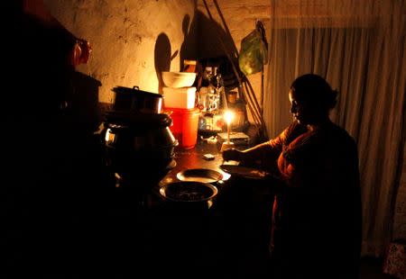 A woman cleans up after dinner in her home during a power cut in Islamabad, Pakistan October 8, 2016. REUTERS/Caren Firouz