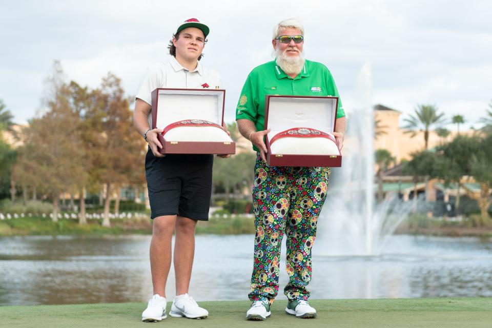 John Daly II and his dad John Daly pose with the trophies after winning the 2021 PNC Championship.