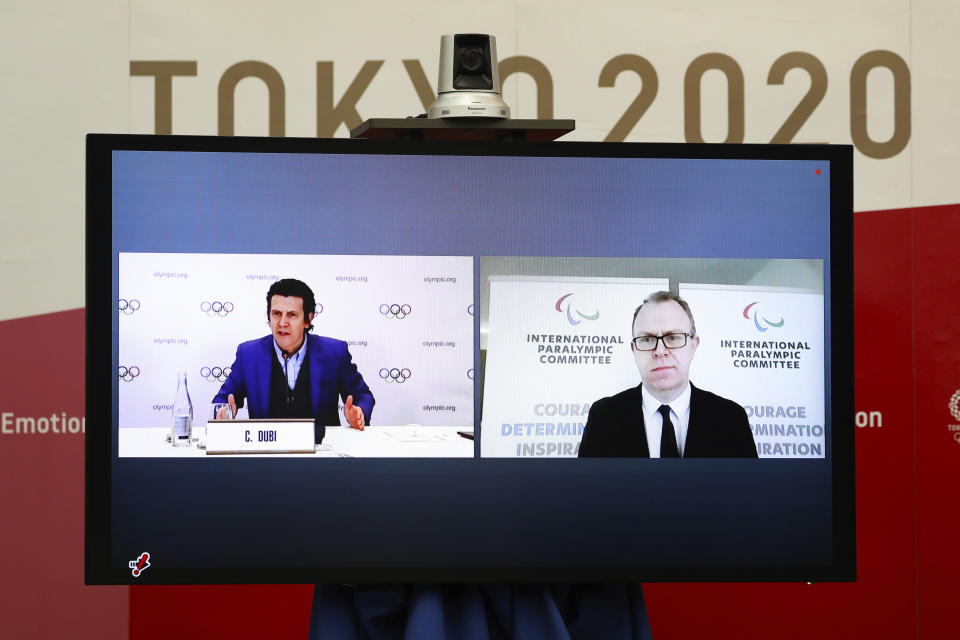 Christophe Dubi, Olympic Games Executive Director for the International Olympic Committee (IOC), left, and Craig Spence, Chief Brand and Communications Officer for the International Paralympic Committee (IPC), join other representatives from the Tokyo Organizing Committee of the Olympic and Paralympic Games (Tokyo 2020) at a Joint press briefing in Tokyo on Wednesday, Feb. 3, 2021. Tokyo 2020, IOC and IPC announced Wednesday they jointly developed and published the first version of "The Playbooks," which contains advice from international and Japanese health experts for COVID-19 countermeasures as well as the guidelines and rules that each games stakeholder will need to observe in order to play their part in ensuing a safe and secure games. (Du Xiaoyi/Pool Photo via AP)