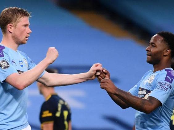 Manchester City celebrate after Kevin De Bruyne scores from the spot (Getty)