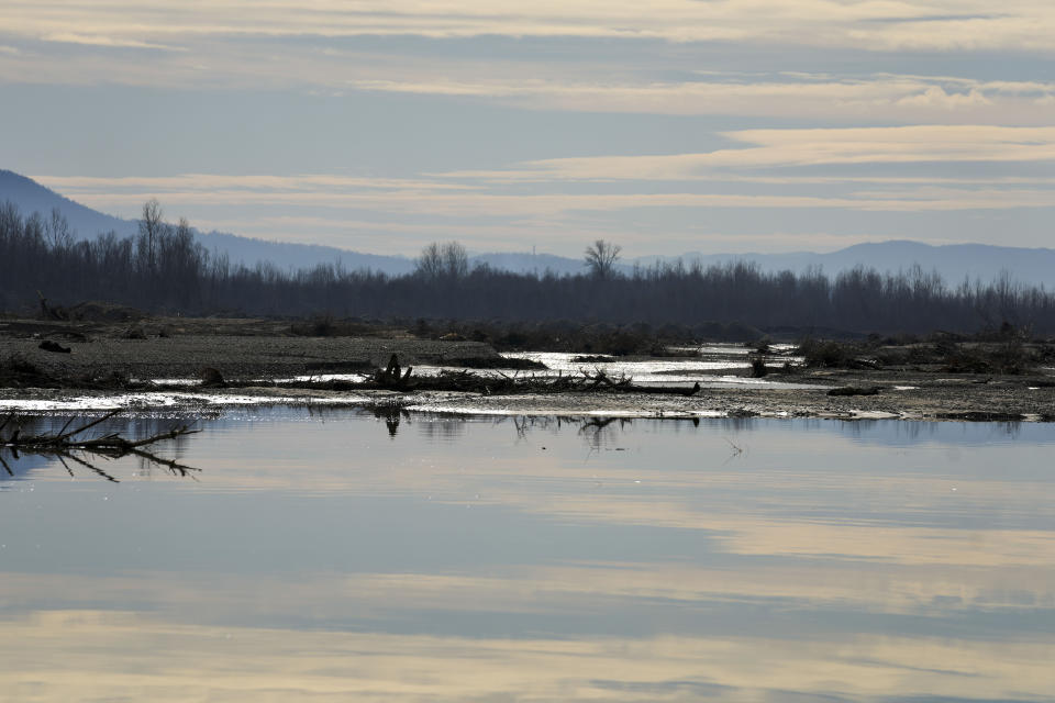 A view of the bank of the Drina River near the village of Amajlije, eastern Bosnia, Sunday, Feb. 4, 2024. In several cities along this river between Bosnia and Serbia, simple, durable gravestones now mark the final resting places of dozens of refugees and migrants who drowned in the area while trying to reach Western Europe.(AP Photo/Darko Vojinovic)