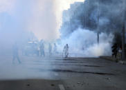 Police fire tear gas to disperse supporters of Pakistan's key opposition party marching in Islamabad, Pakistan, Wednesday, May 25, 2022. Pakistani authorities blocked off all major roads into the capital Islamabad on Wednesday, after a defiant former Prime Minister Imran Khan said he would march with demonstrators to the city center for a rally he hopes will bring down the government and force early elections. (AP Photo/Rahmat Gul)