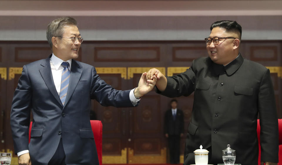 South Korean President Moon Jae-in and North Korean leader Kim Jong Un hold their hands together after watching the mass games performance of "The Glorious Country" at May Day Stadium in Pyongyang, North Korea, Wednesday, Sept. 19, 2018. (Pyongyang Press Corps Pool via AP)