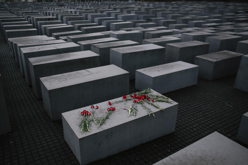 - File- In this Tuesday, Jan. 27, 2015 fill photo, flowers lie on a concrete slab of the Holocaust Memorial to mark the International Holocaust Remembrance Day and commemorating the 70th anniversary of the liberation of the Nazi Auschwitz death camp in Berlin. The Department for Research and Information on Anti-Semitism Berlin, or RIAS documented 410 incidents in Berlin, more than two a day, in the first half of 2020, including physical attacks, property damage, threats, harmful behavior and anti-Semitic propaganda. (AP Photo/Markus Schreiber, File)