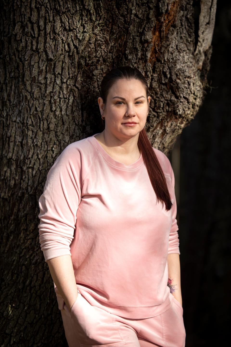 Sarah Duckett stands outside her home in Valrico, Florida. Duckett said she is still dealing with complications from what she said was a botched breast augmentation under Powell's Dr. Katharine Roxanne Grawe. Grawe, known online as Dr. Roxy, gained notoriety for streaming surgeries on TikTok.