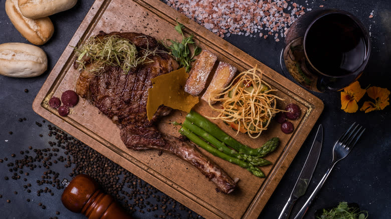 Tomahawk beef steak on cutting board