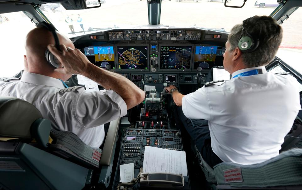 Pilots conduct a pre-flight check in the cockpit of a jet before taking off from Dallas Fort Worth airport in Grapevine, Texas, on Dec. 2, 2020.