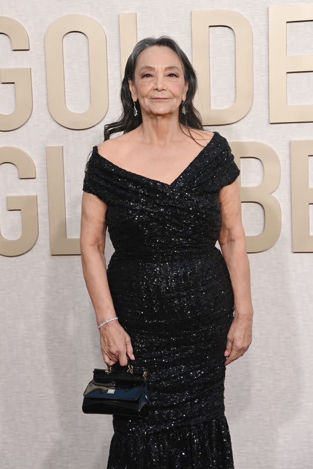 Tantoo Cardinal in a simplistic, off-the-shoulder black gown. 