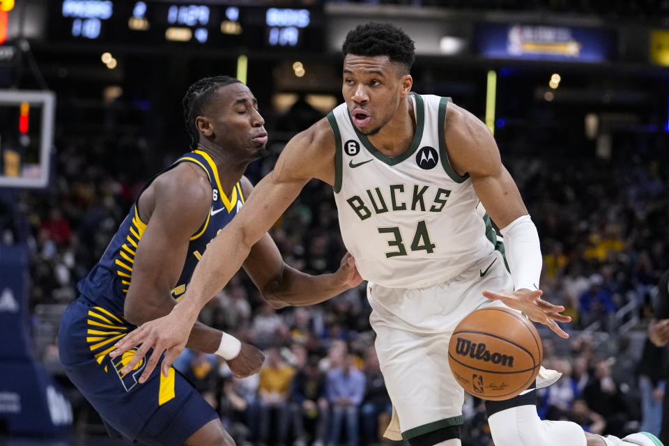 Milwaukee Bucks forward Giannis Antetokounmpo (34) drives on Indiana Pacers forward Aaron Nesmith (23) during the second half of an NBA basketball game in Indianapolis, Wednesday, March 29, 2023. (AP Photo/Michael Conroy)