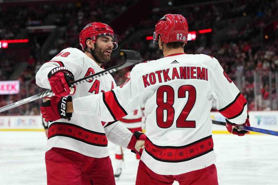 Carolina Hurricanes center Jesperi Kotkaniemi (82) celebrates his goal against the Florida Panthers with left wing Jordan Martinook (48) during the first period at Amerant Bank Arena.