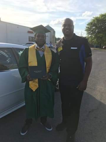 Timothy Harrison poses in his cap and gown with his Waffle House manager, Cedric Hampton. Harrison made it to his graduation ceremony with the help of his Waffle House co-workers