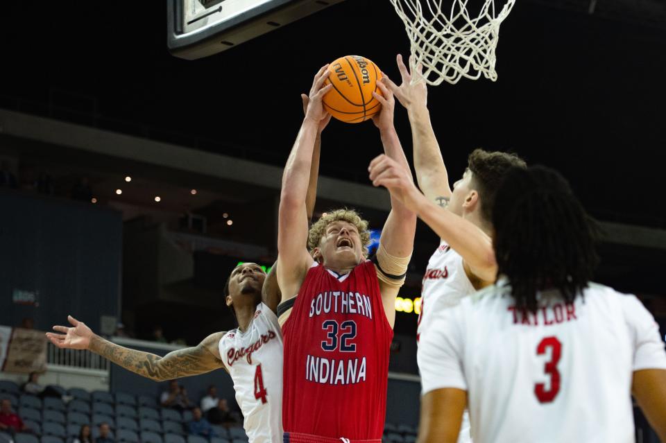 Southern Indiana’s Jacob Polakovich (32) sails toward the rebound against the Southern Illinois University Edwardsville Cougars during the first round of the Ohio Valley Conference at Ford Center on Wednesday, March 1, 2023.
