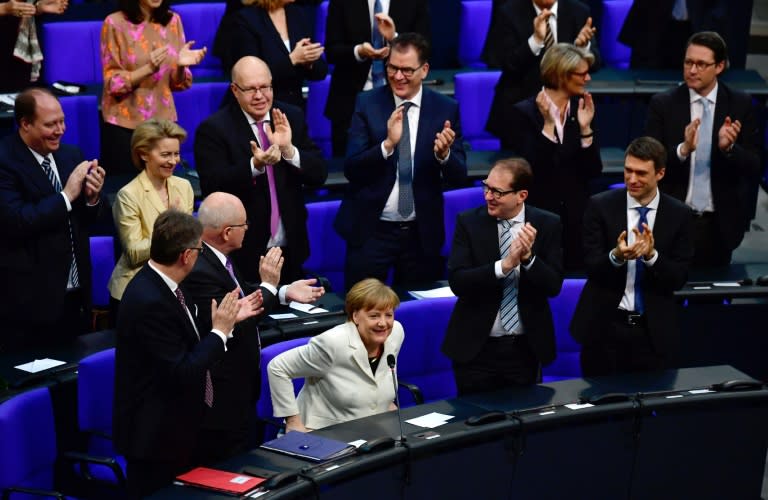 Lawmakers in Berlin's glass-domed Reichstag voted 364-315 with nine abstentions for Merkel